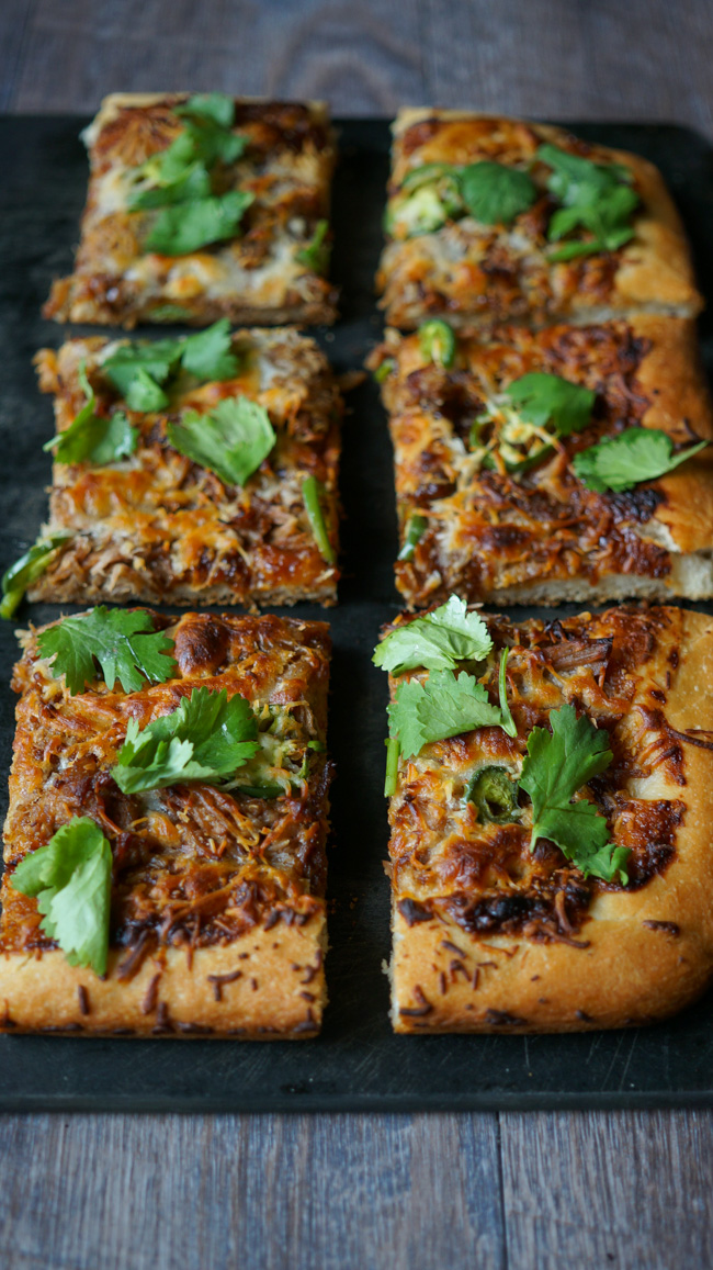 Spicy Hoisin Pork Pizza. Homemade pizza dough with a soy peanut butter hoisin sauce, tender pulled pork, jalapeno slices, and mozzarella cheese then sprinkled with cilantro.