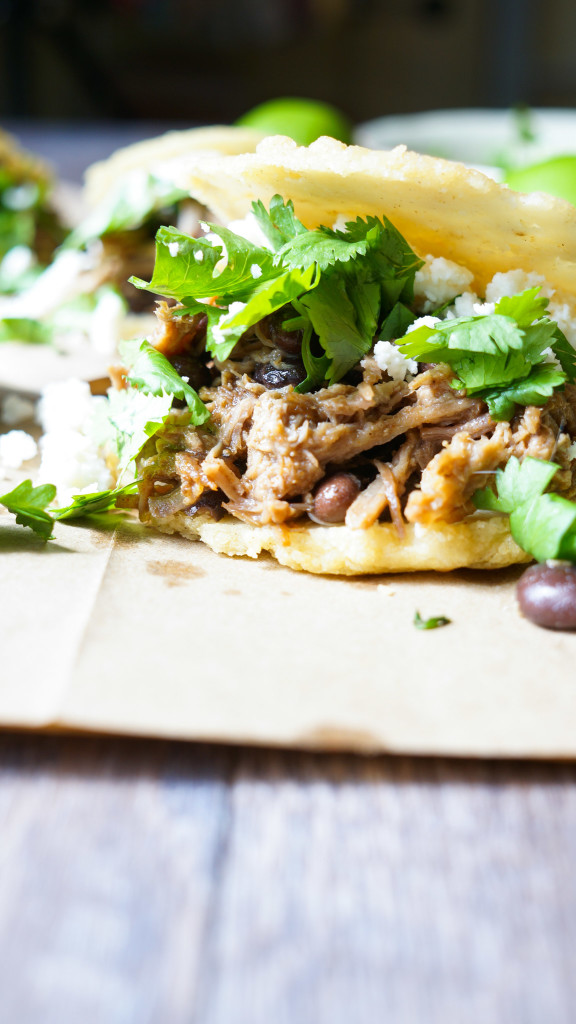 Venezuelan Pork Arepas. Slow roasted pork with spiced black beans, cotija cheese, and cilantro all stuffed inside a cornmeal arepa.