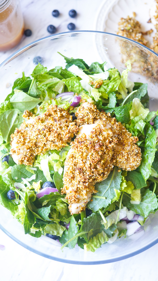 This Pistachio Crusted Chicken Salad is full of flavor! Packed with nuts, blueberries, and healthy greens, you won't want to stop eating!