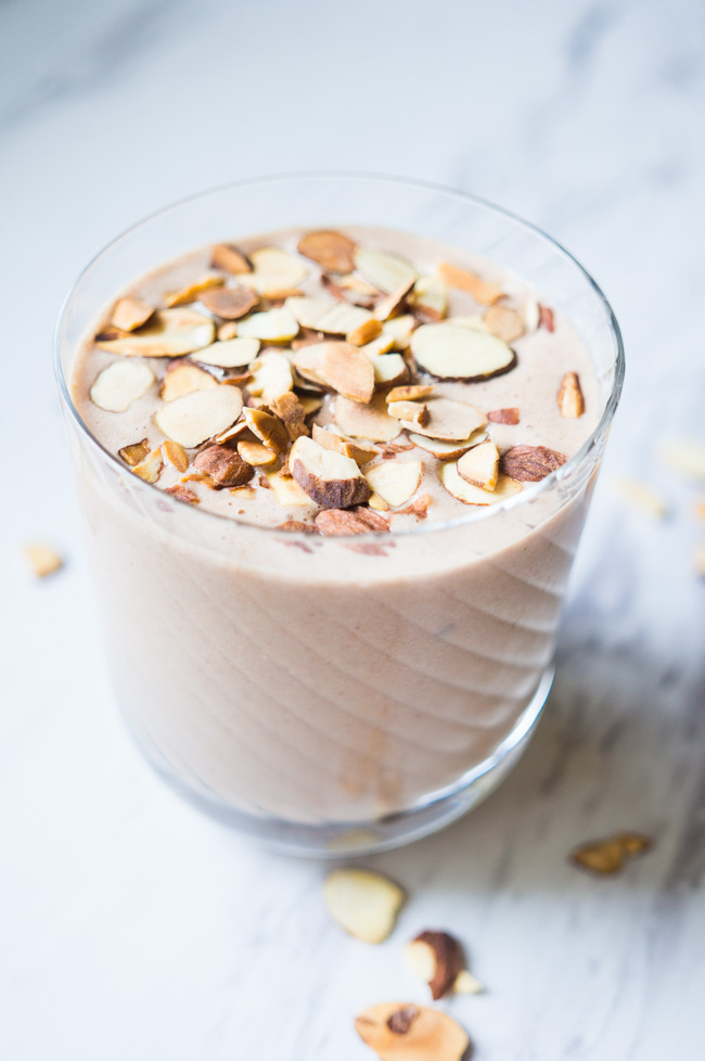 Coconut Banana Smoothie with toasted almonds, peanut butter, and honey! So creamy and delicious.