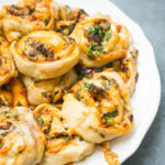 Mushroom and Spinach Cheesy Pizza Rolls. A fun alternative to pizza nights, this ooey gooey, veggie loaded cheesy pizza rolls are sure to be a family hit!