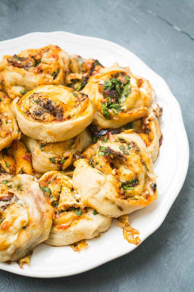 Mushroom and Spinach Cheesy Pizza Rolls. A fun alternative to pizza nights, these ooey gooey, veggie loaded cheesy pizza rolls are sure to be a family hit!