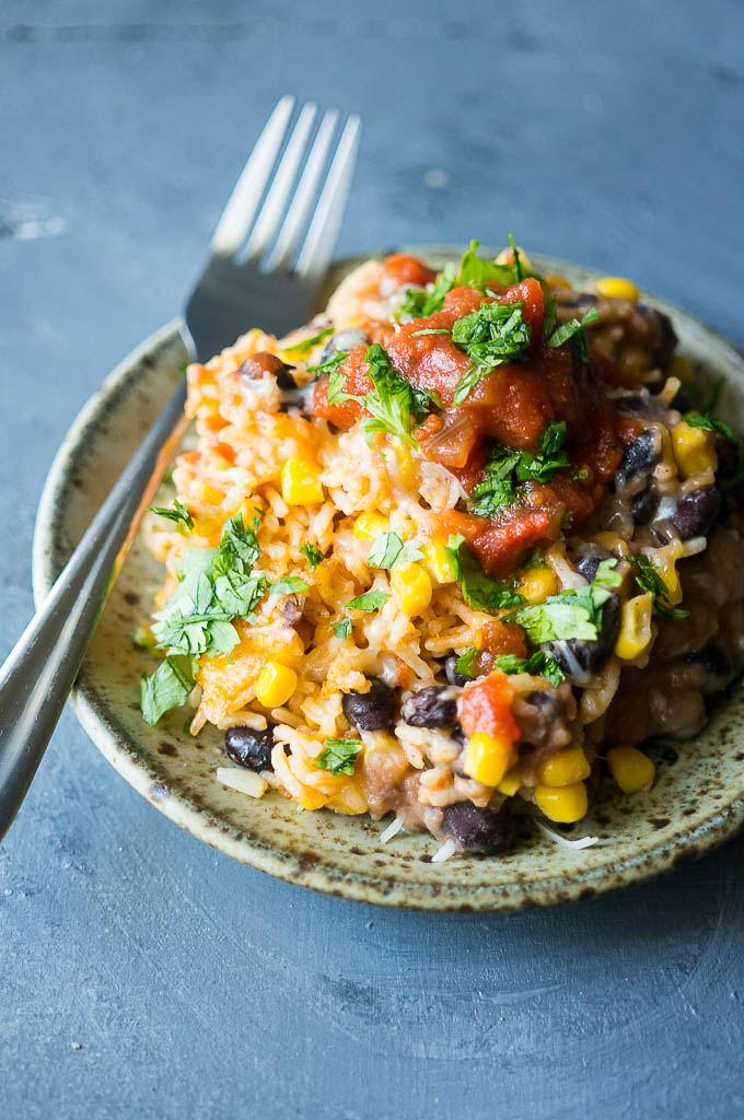 This Pressure Cooker Spanish Rice Bake is tex-mex comfort food at its finest. Layer everything in your pressure cooker and dinner is ready in less than 30 minutes!