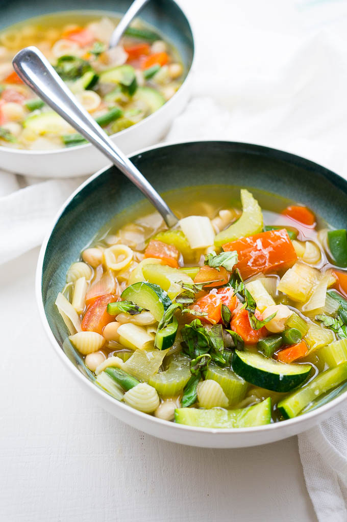 Provençal Summer Vegetable Soup has a light, delicate broth with a simple mix of warm weather produce, small pasta shells, cannellini beans, and fresh ribboned basil.