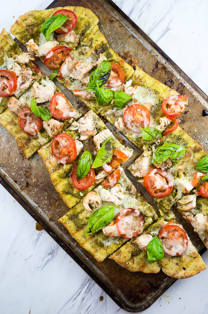 Caprese and Pesto Grilled Chicken Pizza is a fresh summer favorite guaranteed to be polished off in one sitting!