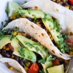 Corn, Black Bean, and Avocado Tacos - we're going meatless but still totally satisfying with these veggie loaded tacos!