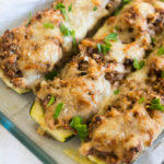 Zuccanoes (stuffed zucchini) are an ultra filling vegetarian dinner with almonds, rice, savory veggies, and fresh herbs!