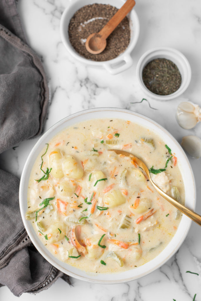 Creamy Chicken Soup in a white bowl on a marble background